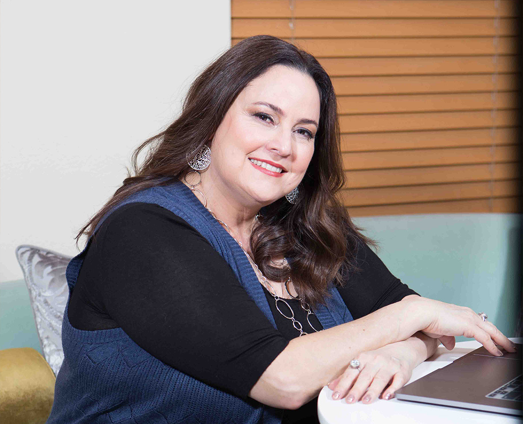 Dena Skoko seated at a laptop